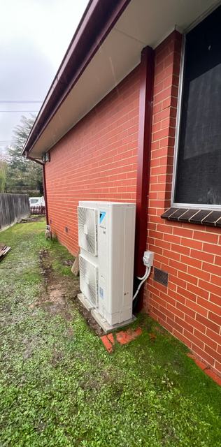 Ducted outdoor unit installed beside a home