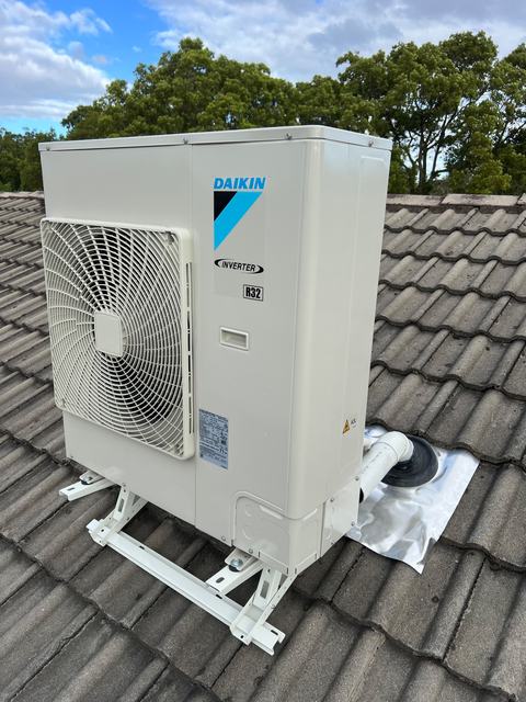 Daikin outdoor unit on a tiled-roof frame